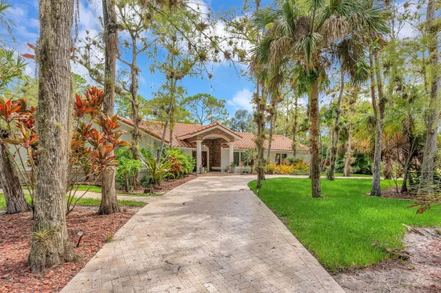 a pathway of a house with a yard