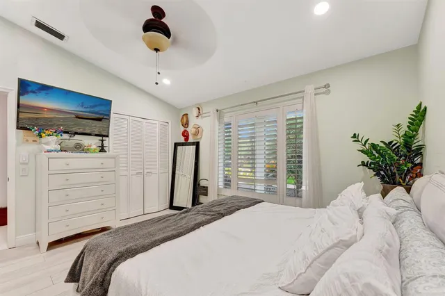 a living room with patio furniture and a floor to ceiling window