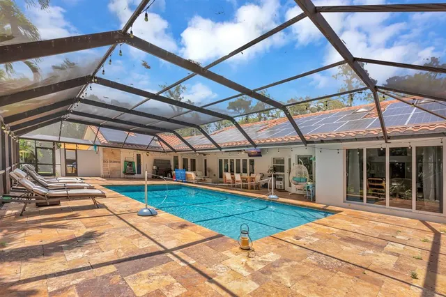 an aerial view of a house with a yard and garden