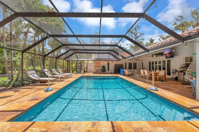 an aerial view of a house with a yard basket ball court and outdoor seating