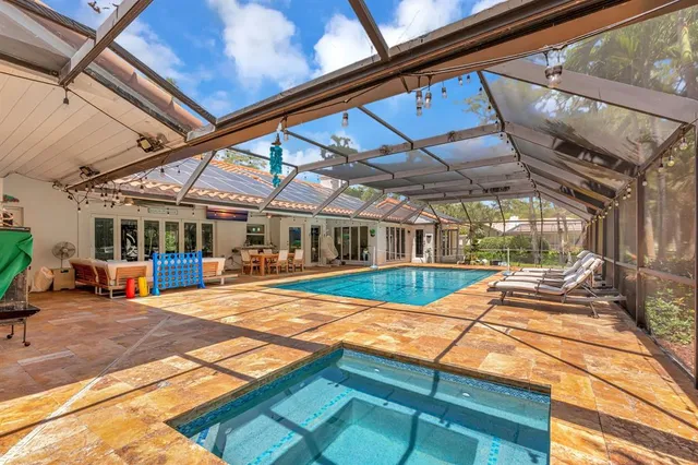 an aerial view of residential houses with outdoor space and trees all around