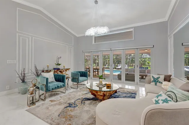 a living room with furniture and a chandelier