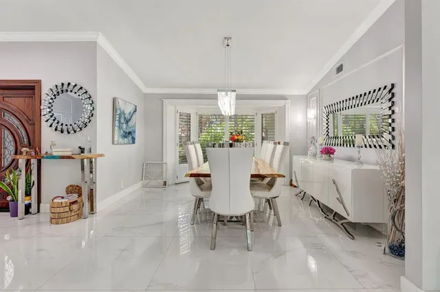 a kitchen with stainless steel appliances a stove top oven a sink a refrigerator and white cabinets