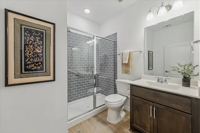 a bathroom with a double vanity sink mirror and shower
