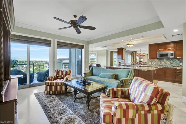 a living room with furniture and kitchen view