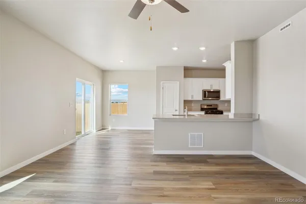 a view of kitchen with granite countertop window and stainless steel appliances