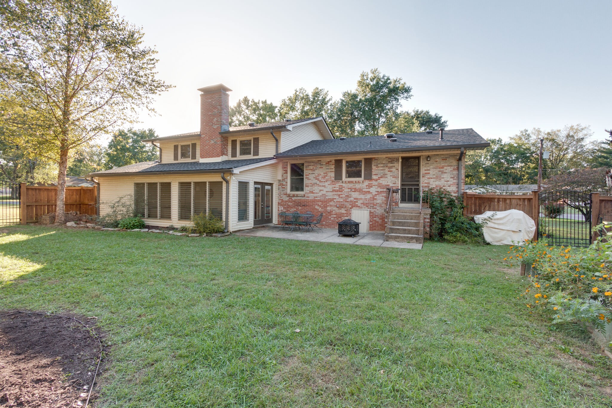 1202 Raleigh Court Murfreesboro, TN 37130 - Photo 32 of 34 a view of a house with backyard and a garden