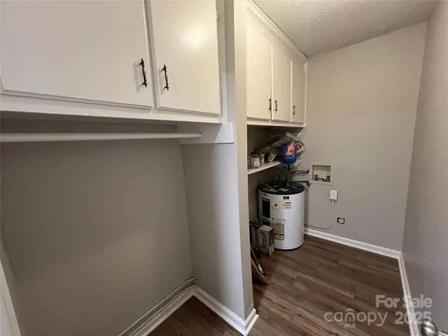 a front view of a building with lot of cars and trees