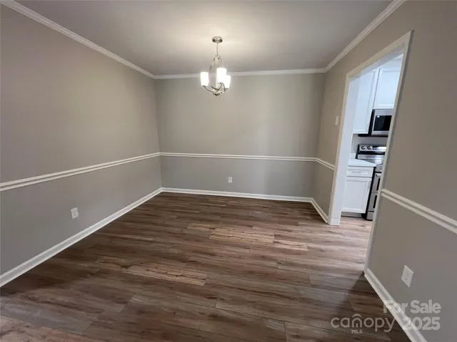 a view of a room with wooden floor and staircase