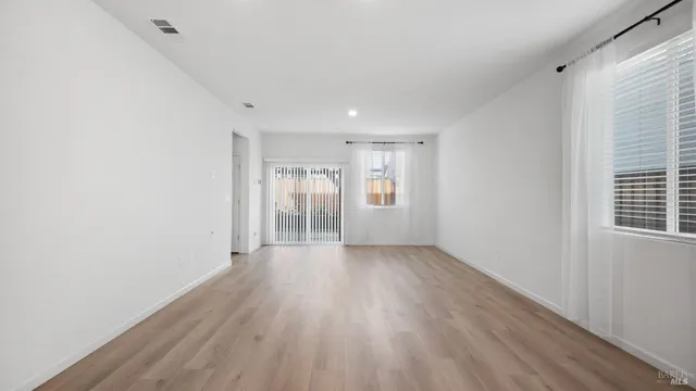 a view of a patio with a table and chairs