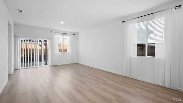 a backyard of a house with table and chairs
