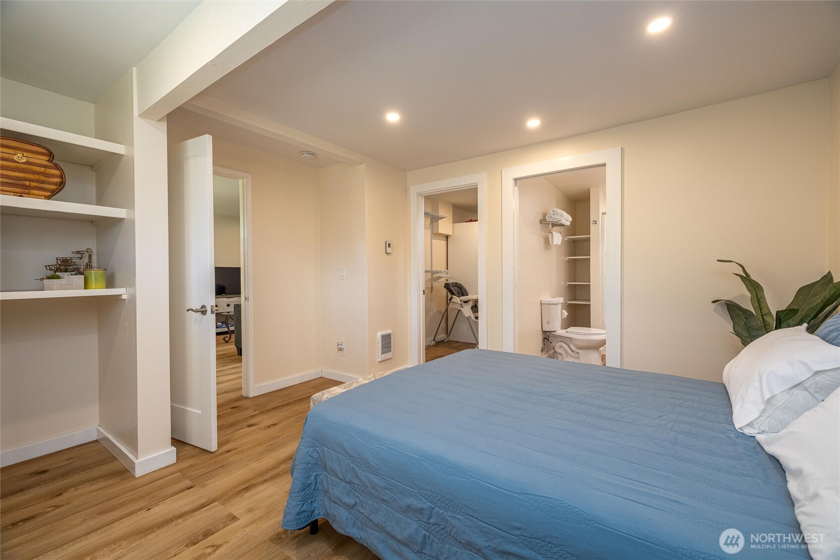 3456 Emma Road Bellingham, WA 98226 - Photo 12 of 32 a bedroom with a large bed closet and wooden floor