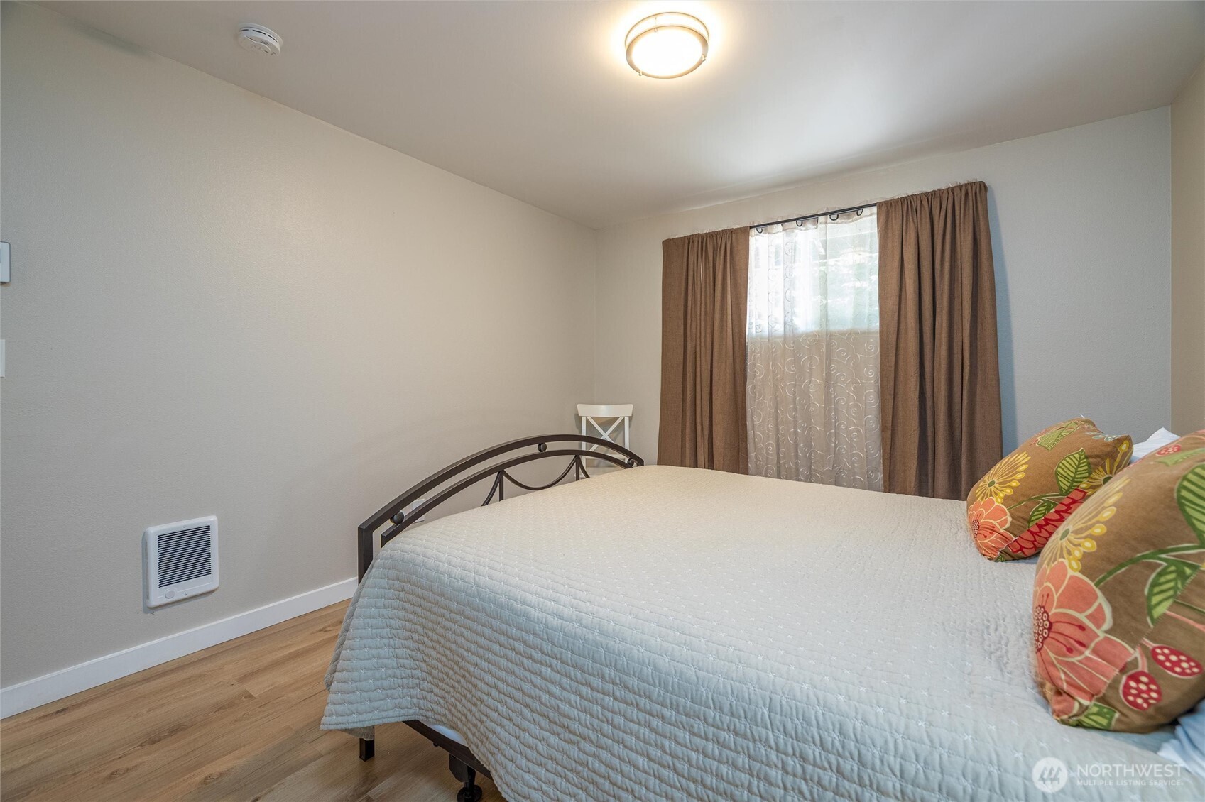 3456 Emma Road Bellingham, WA 98226 - Photo 17 of 32 a bedroom with a bed and wooden floor