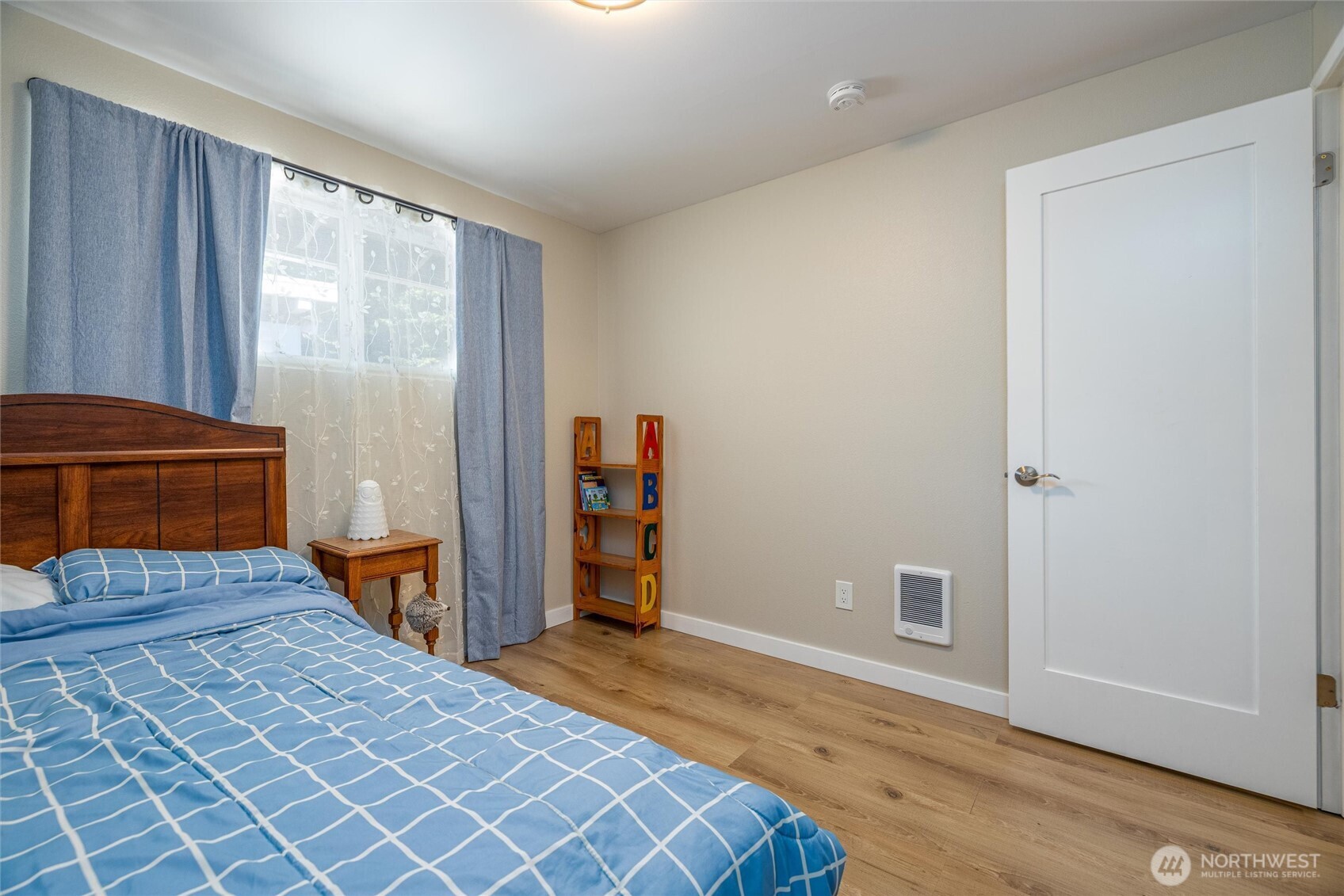 3456 Emma Road Bellingham, WA 98226 - Photo 22 of 32 a bedroom with a bed and wooden floor
