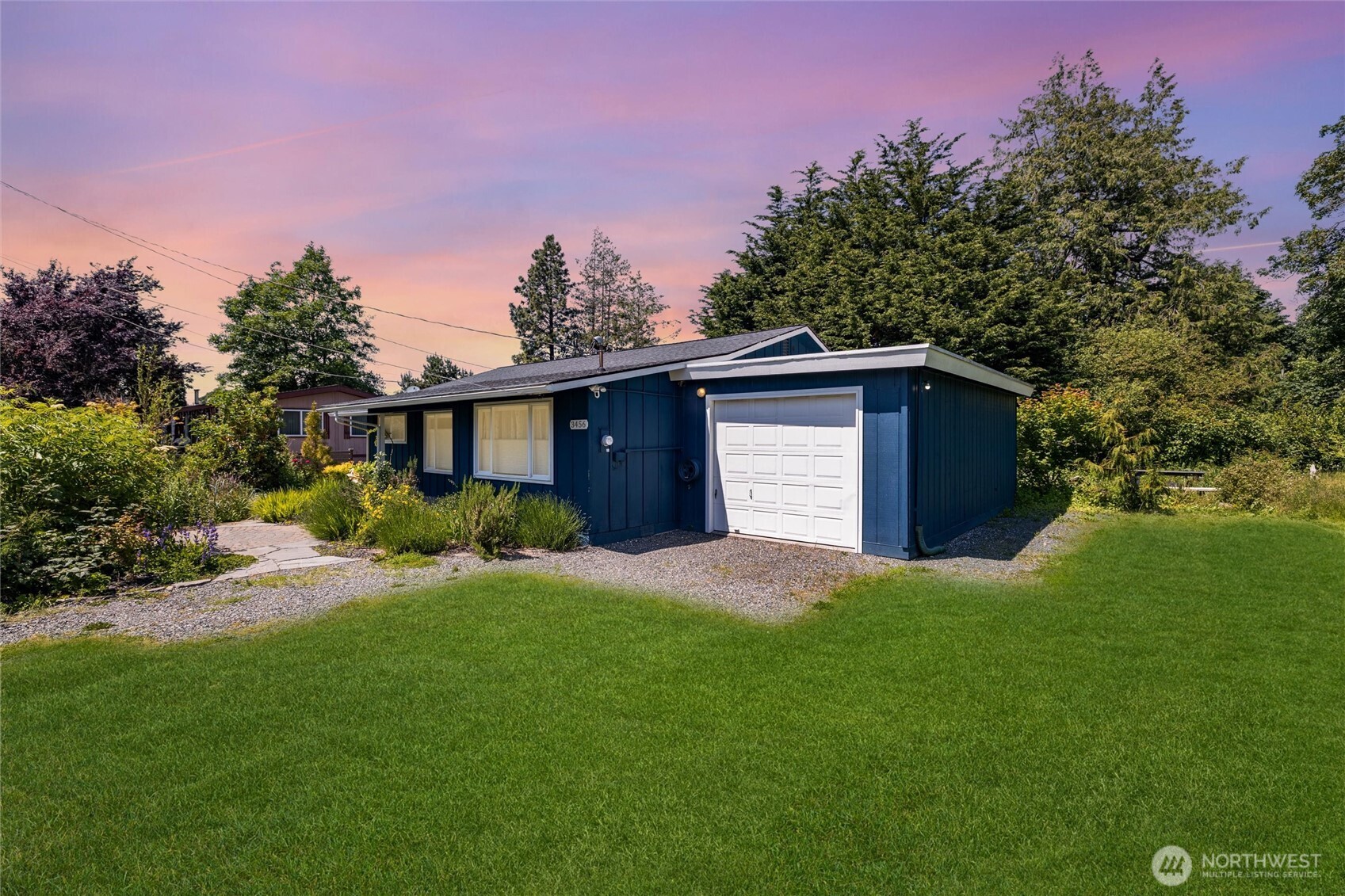 3456 Emma Road Bellingham, WA 98226 - Photo 3 of 32 a front view of a house with a yard and trees