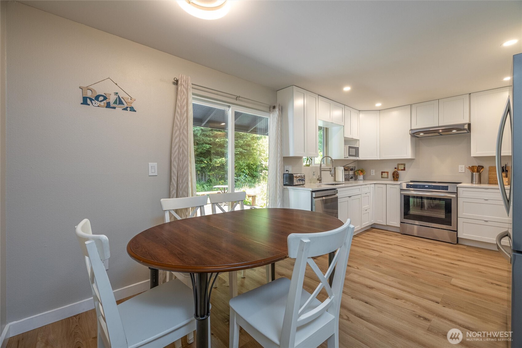 3456 Emma Road Bellingham, WA 98226 - Photo 8 of 32 a kitchen with kitchen island a dining table and chairs