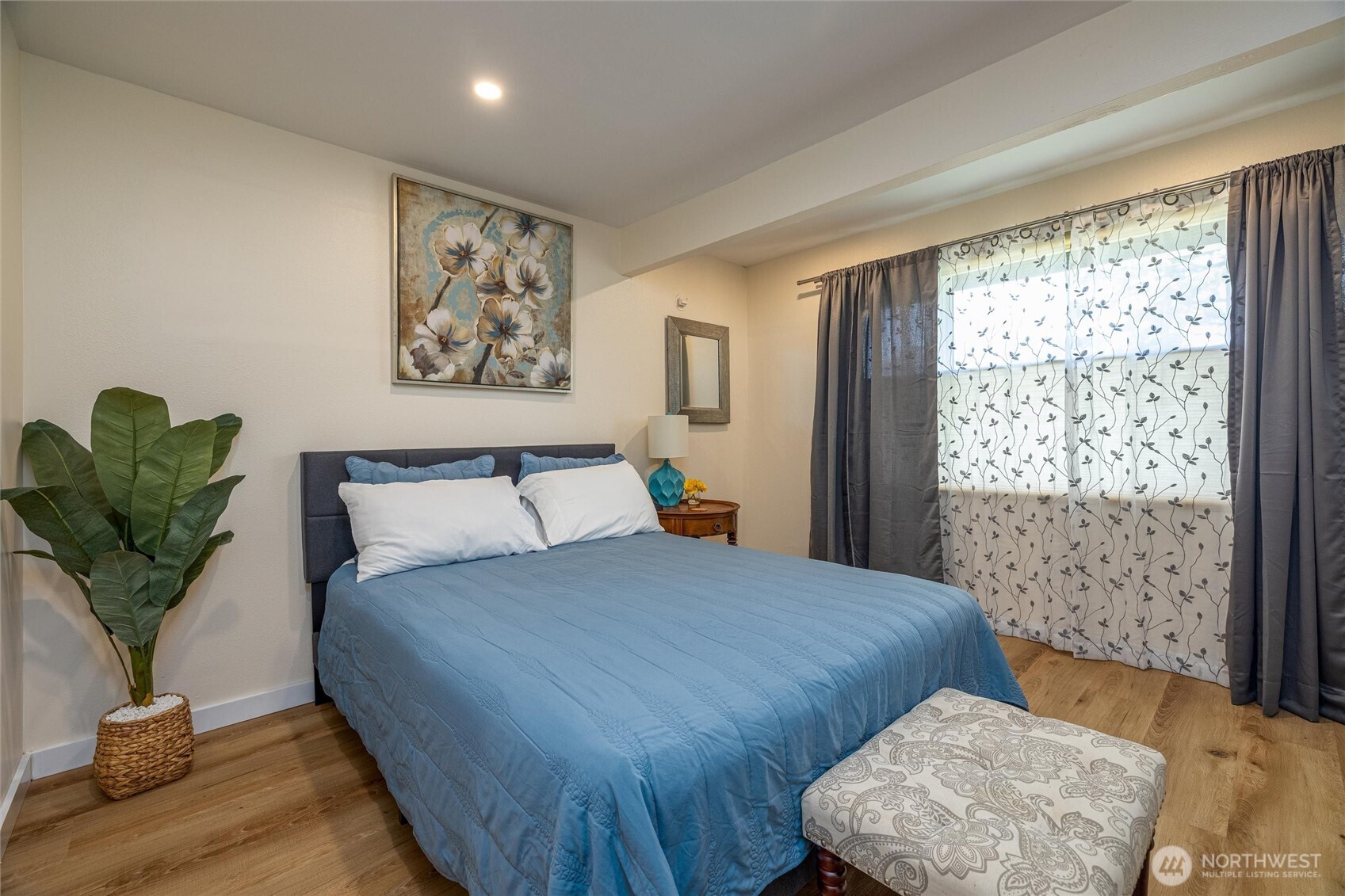 3456 Emma Road Bellingham, WA 98226 - Photo 10 of 32 a bedroom with a large bed and a potted plant