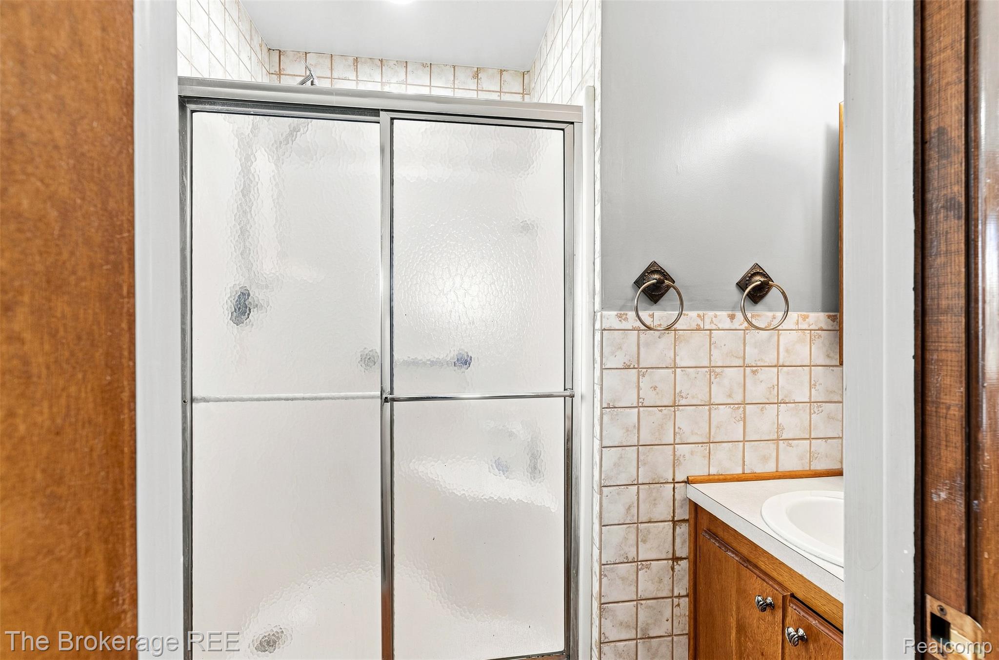 4443 North Gale Road Davison, MI 48423 - Photo 30 of 36 Enclosed shower with sliding glass doors, white tiled walls, and recessed lighting