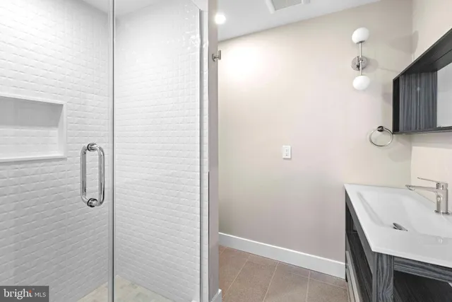 a bathroom with a sink a mirror and shower