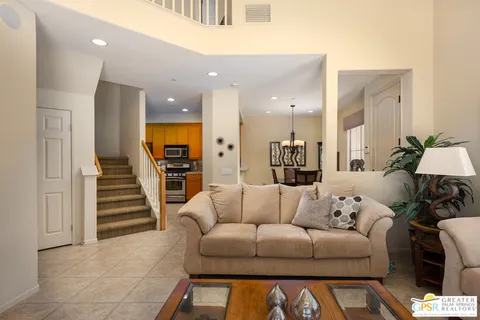 a living room with furniture and a ceiling fan