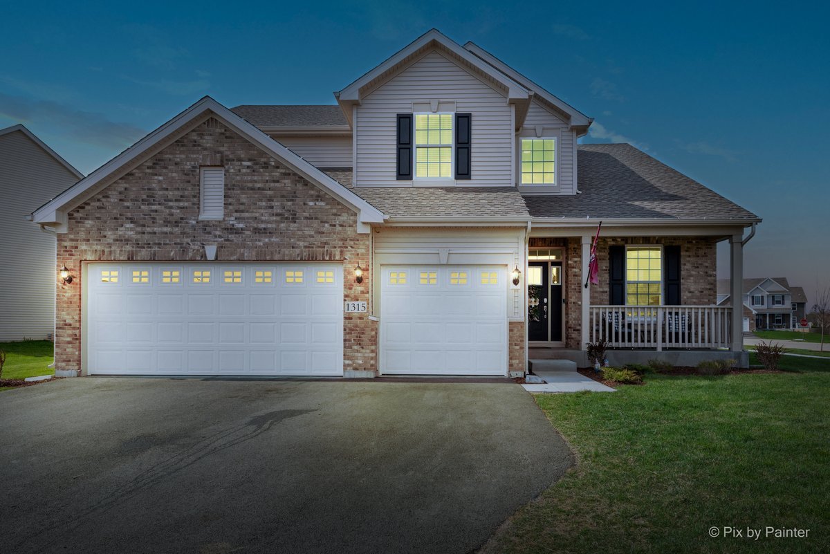 1315 Sage Circle Joliet, IL 60431 - Photo 1 of 27 a front view of a house with a yard and garage