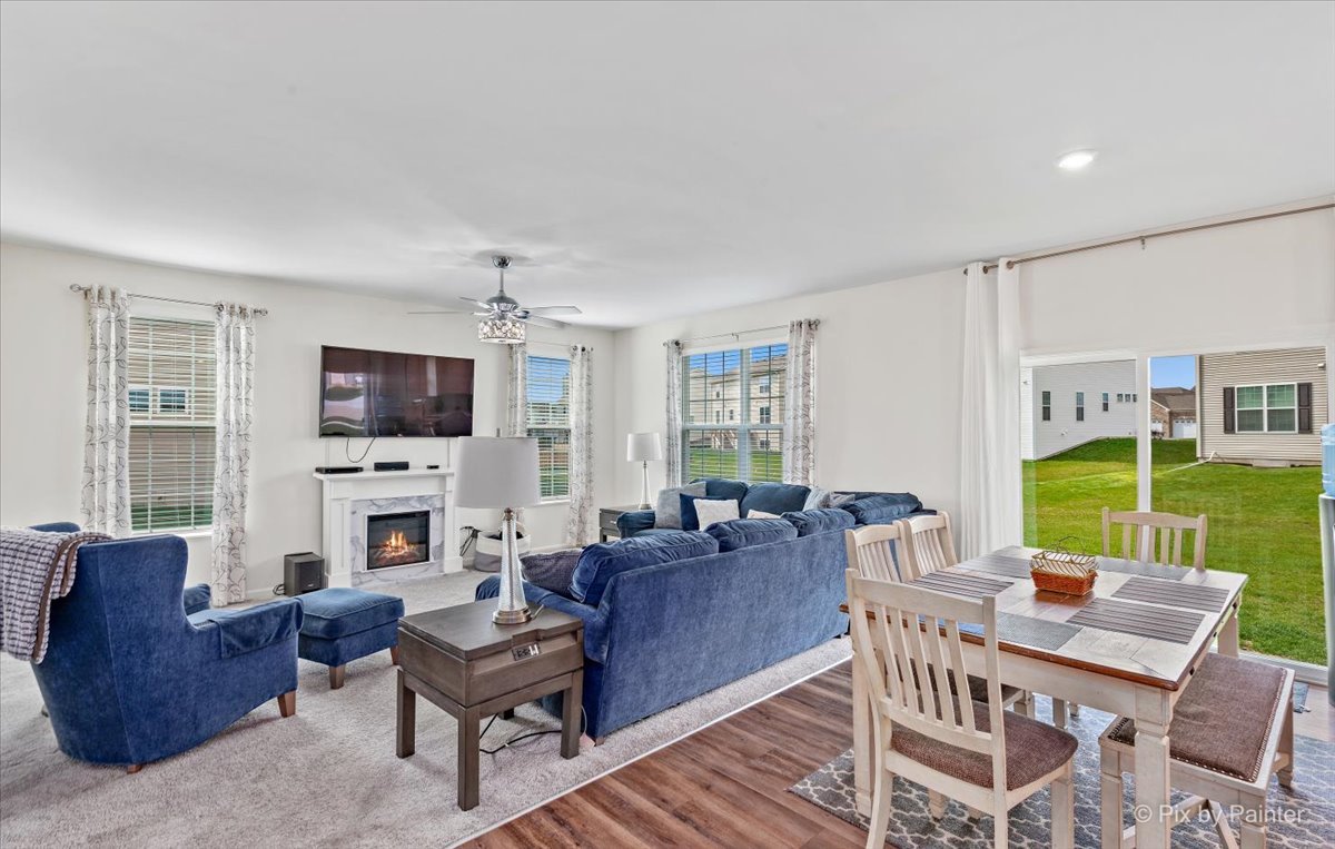 1315 Sage Circle Joliet, IL 60431 - Photo 12 of 27 a living room with furniture a flat screen tv and a fireplace