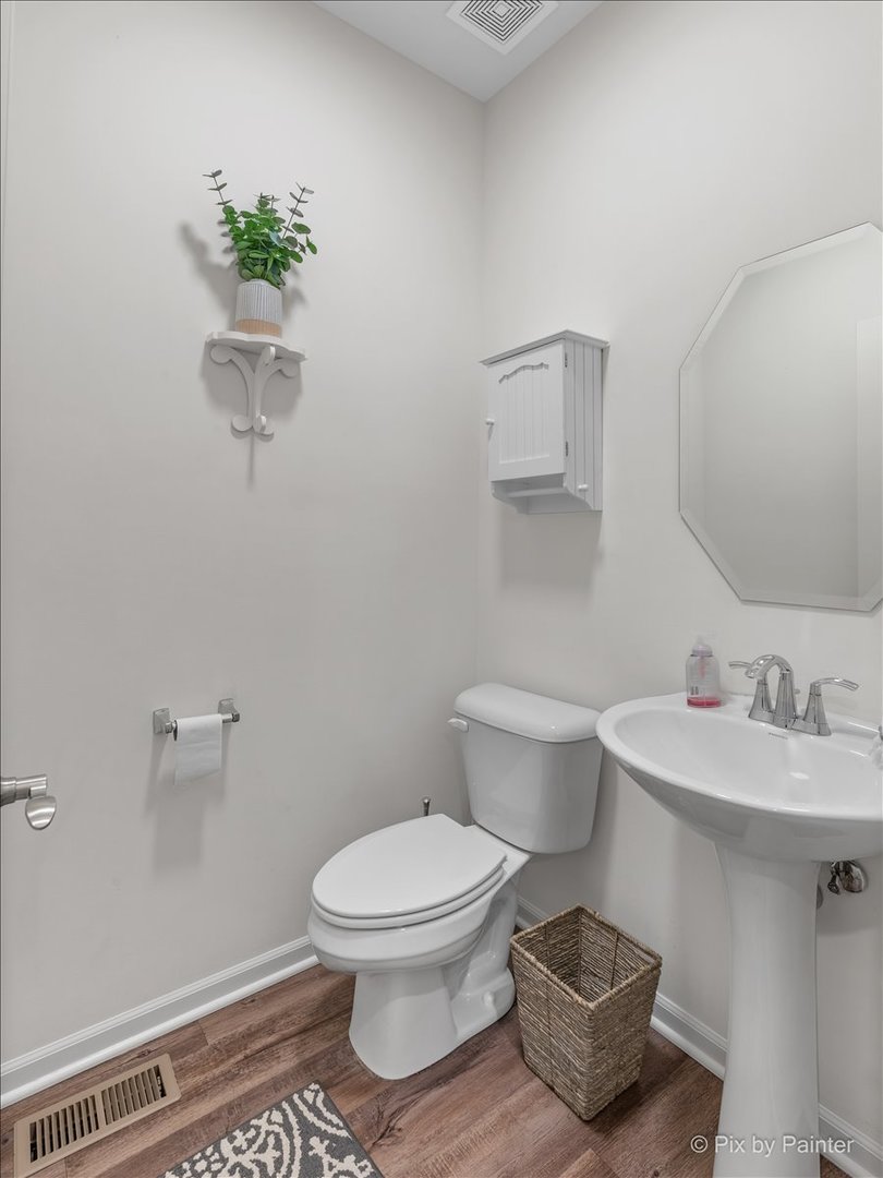 1315 Sage Circle Joliet, IL 60431 - Photo 15 of 27 a white toilet sitting next to a bathroom sink