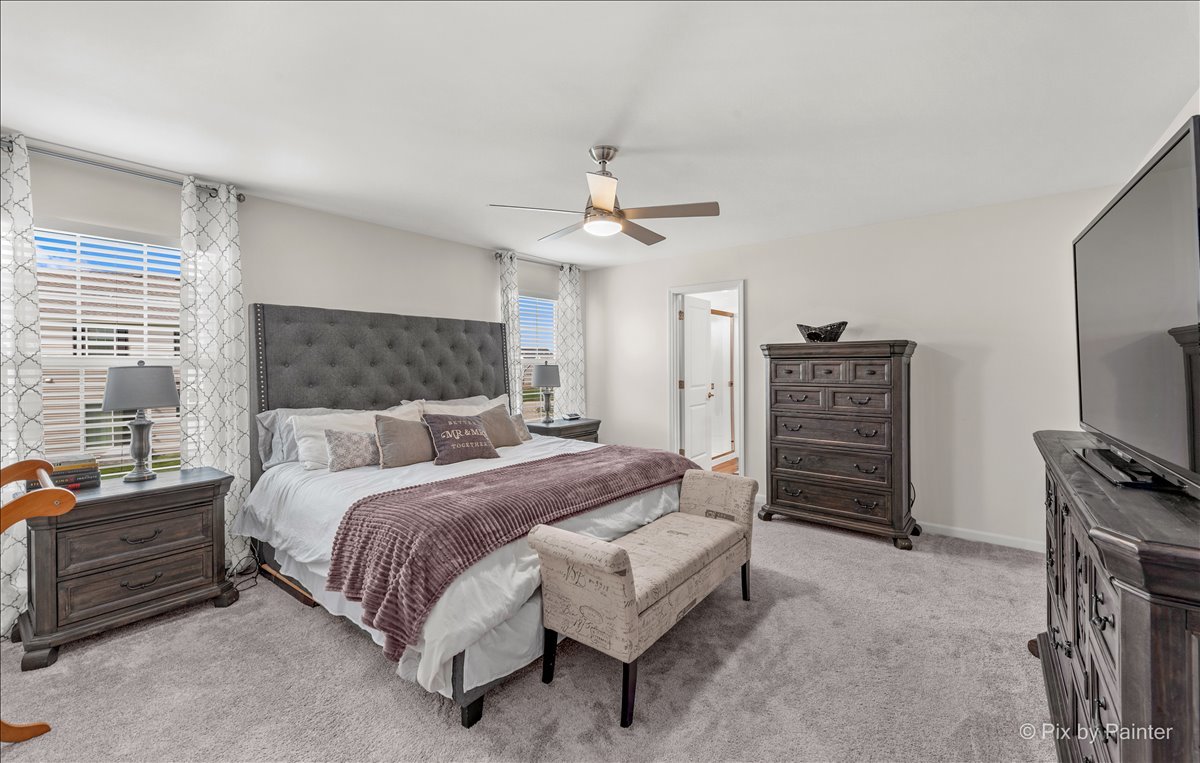 1315 Sage Circle Joliet, IL 60431 - Photo 17 of 27 a bedroom with a bed dresser and a flat tv screen