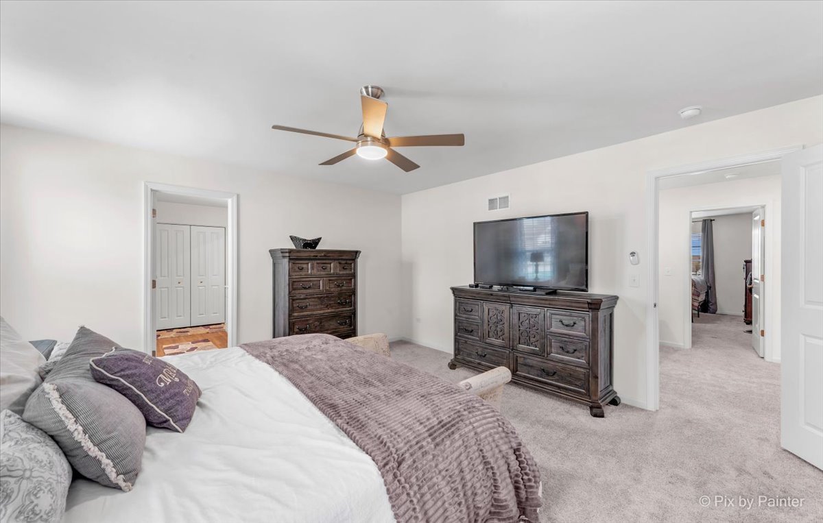 1315 Sage Circle Joliet, IL 60431 - Photo 18 of 27 a bedroom with a bed and a flat screen tv