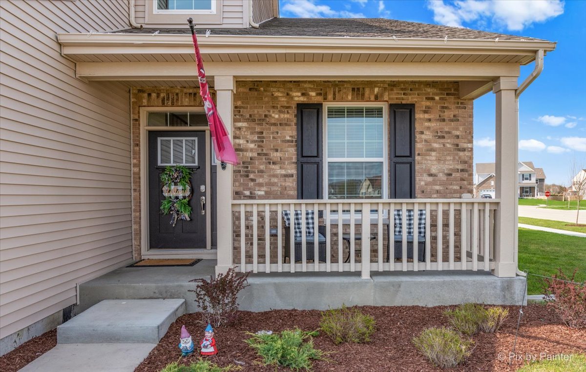 1315 Sage Circle Joliet, IL 60431 - Photo 2 of 27 a view of a house with a small yard and floor to ceiling window and wooden fence