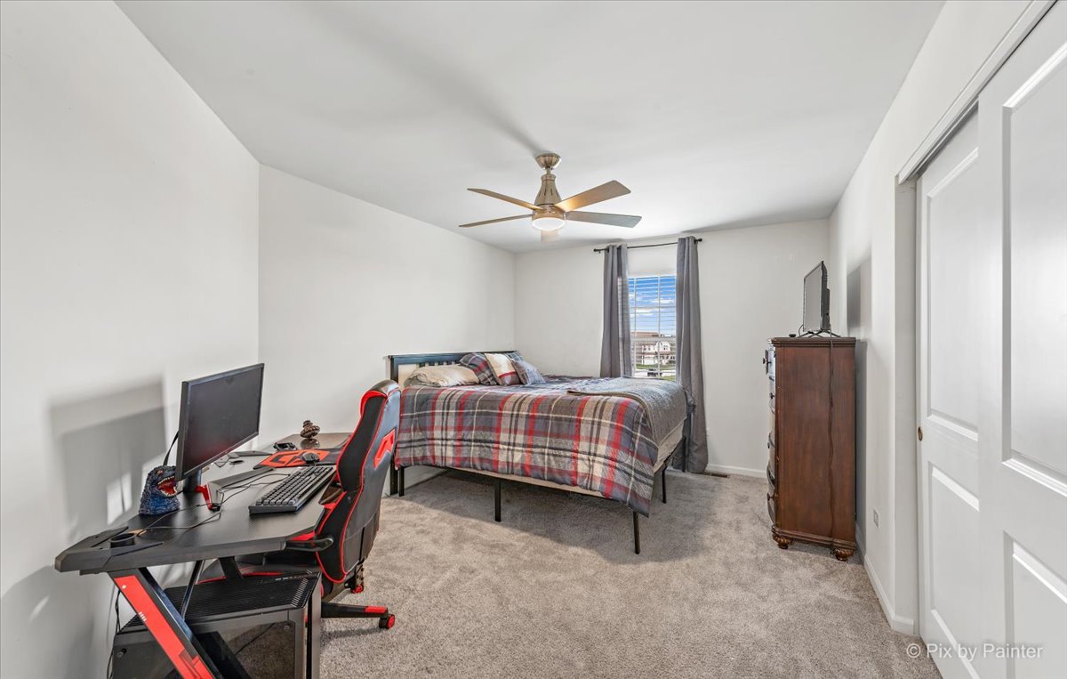 1315 Sage Circle Joliet, IL 60431 - Photo 21 of 27 a bedroom with a bed and a desk