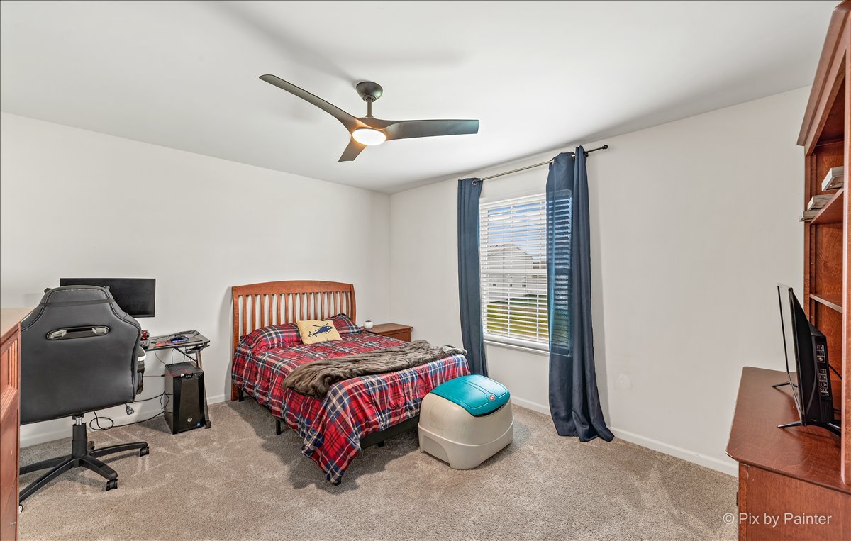 1315 Sage Circle Joliet, IL 60431 - Photo 23 of 27 a bedroom with a bed and large windows