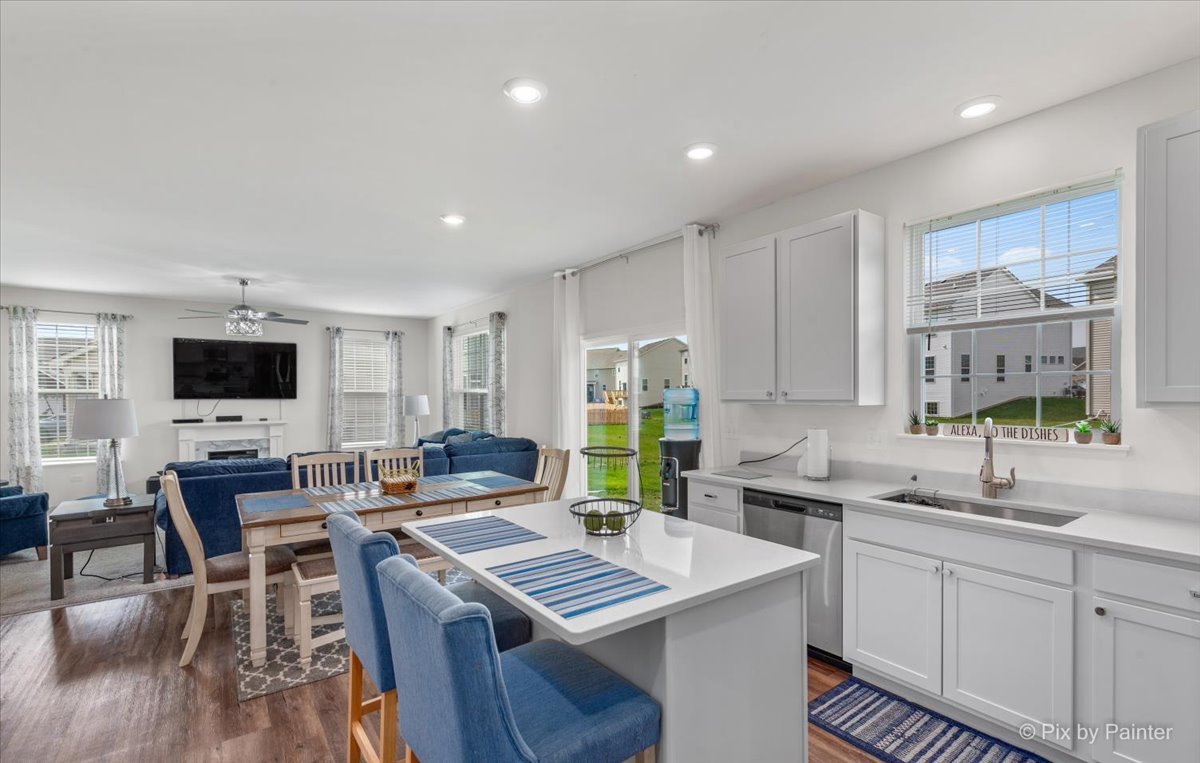 1315 Sage Circle Joliet, IL 60431 - Photo 8 of 27 a kitchen with stainless steel appliances a stove a sink dishwasher a microwave a dining table and chairs