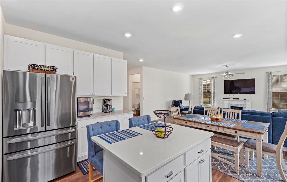 1315 Sage Circle Joliet, IL 60431 - Photo 10 of 27 a kitchen with stainless steel appliances granite countertop a sink stove and refrigerator with wooden floor