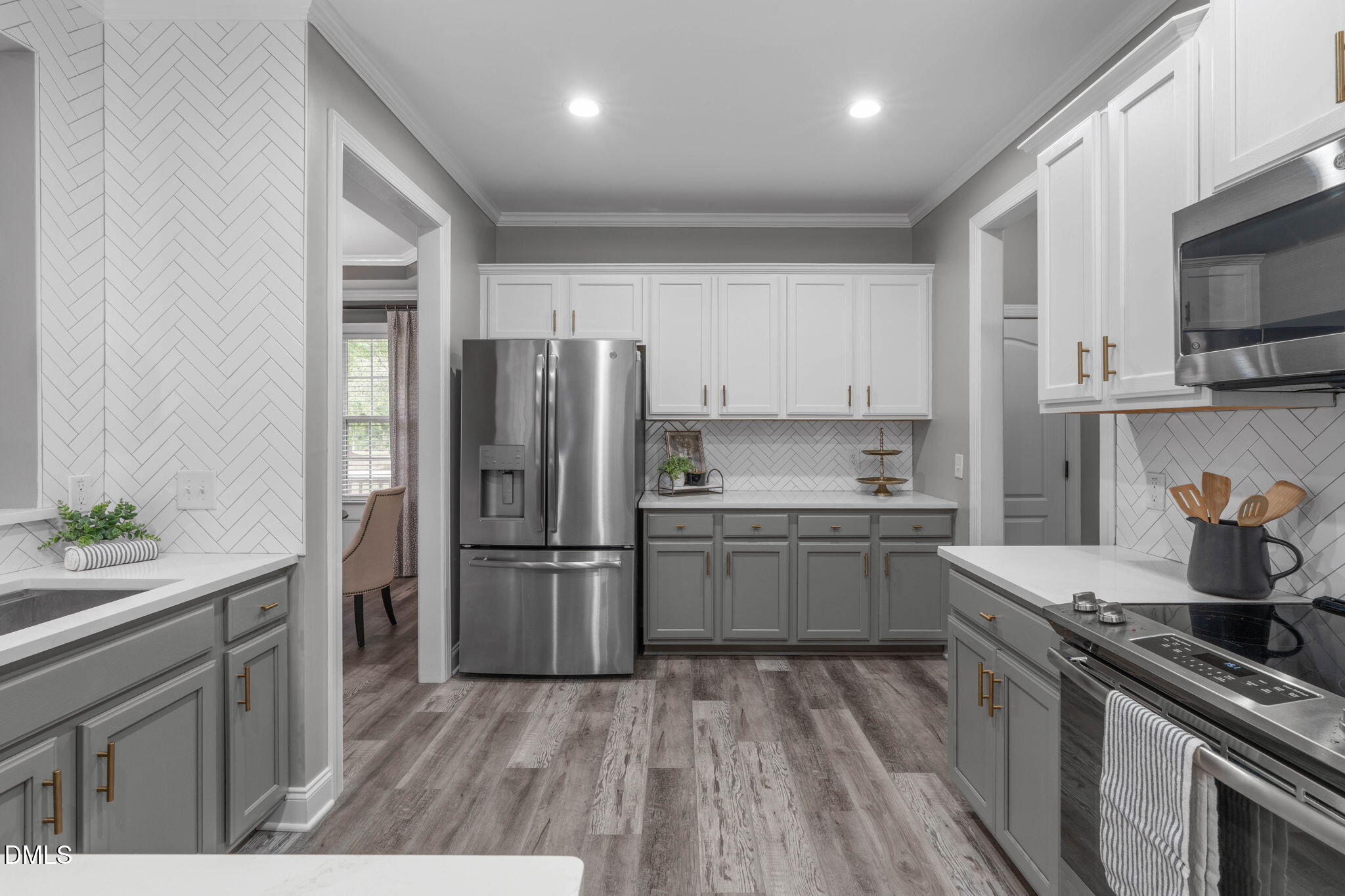 2450 Rolling Tracks Road Willow Spring, NC 27592 - Photo 22 of 64 a kitchen with a sink a refrigerator and a stove top oven
