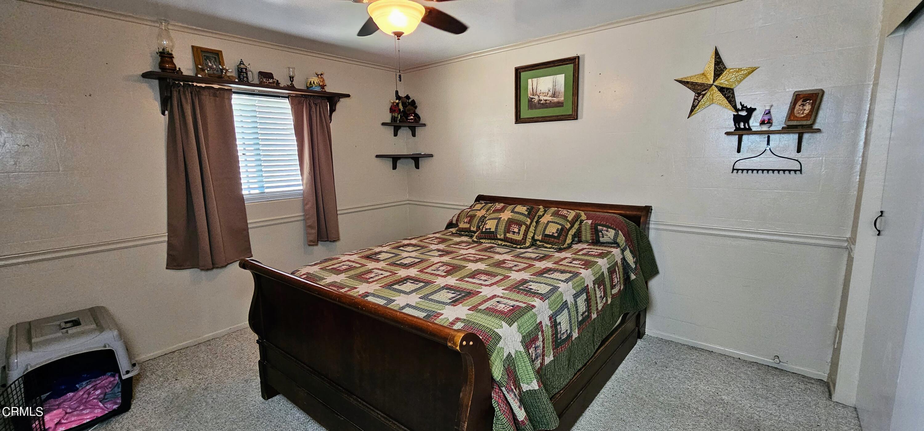 1157 Eugene Maricopa Ca Maricopa, CA 93252 - Photo 12 of 28 a bedroom with a bed and painting on the wall