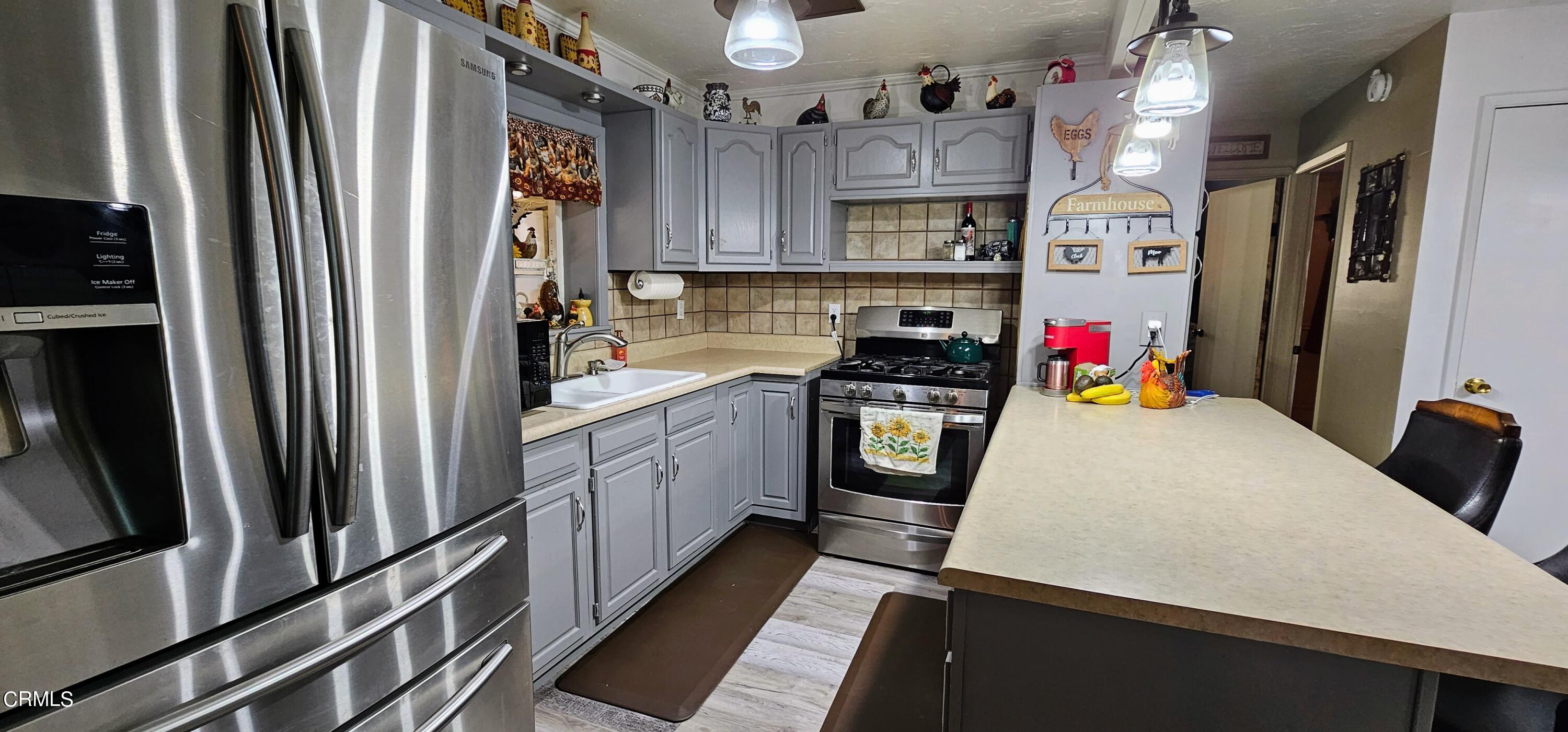 1157 Eugene Maricopa Ca Maricopa, CA 93252 - Photo 2 of 28 a kitchen with stainless steel appliances a refrigerator sink and white cabinets