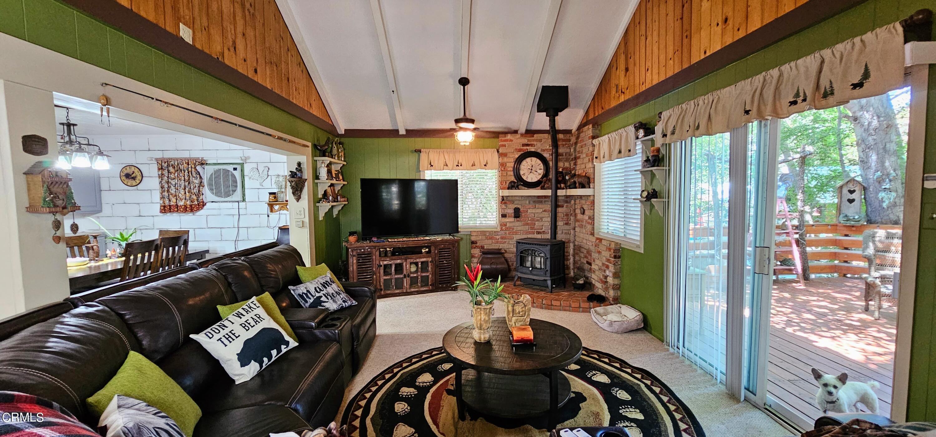 1157 Eugene Maricopa Ca Maricopa, CA 93252 - Photo 8 of 28 a living room with furniture a flat screen tv and a floor to ceiling window