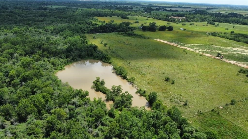 1966 Hluchan Road Sealy, TX 77474 - Photo 2 of 16 an aerial view of a houses with outdoor space and trees all around