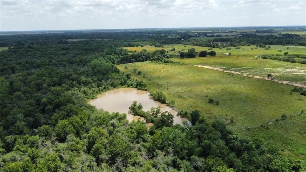 1966 Hluchan Road Sealy, TX 77474 - Photo 10 of 16 an aerial view of ocean with residential houses with outdoor space and trees