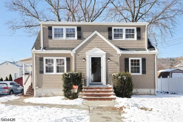 a view of a house with a yard covered in snow