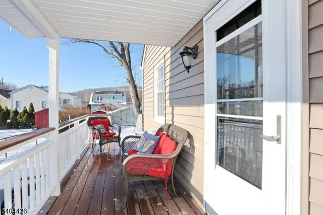 a balcony with table and chairs