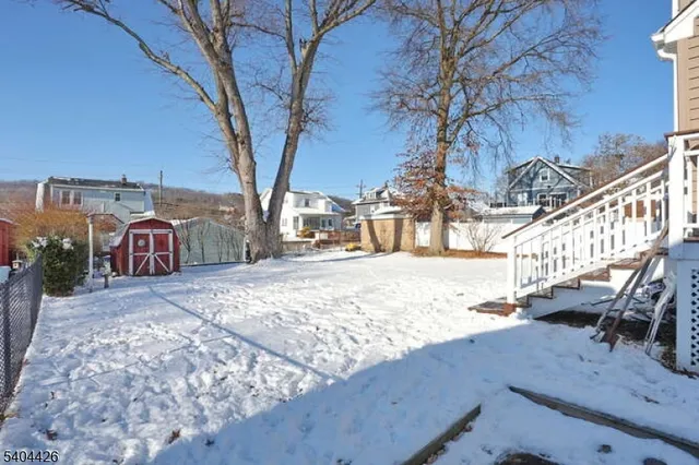 a view of a house with snow on the road