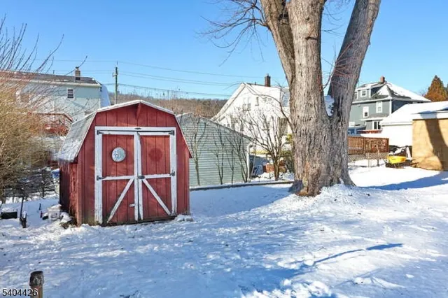 a view of a wooden house with a yard