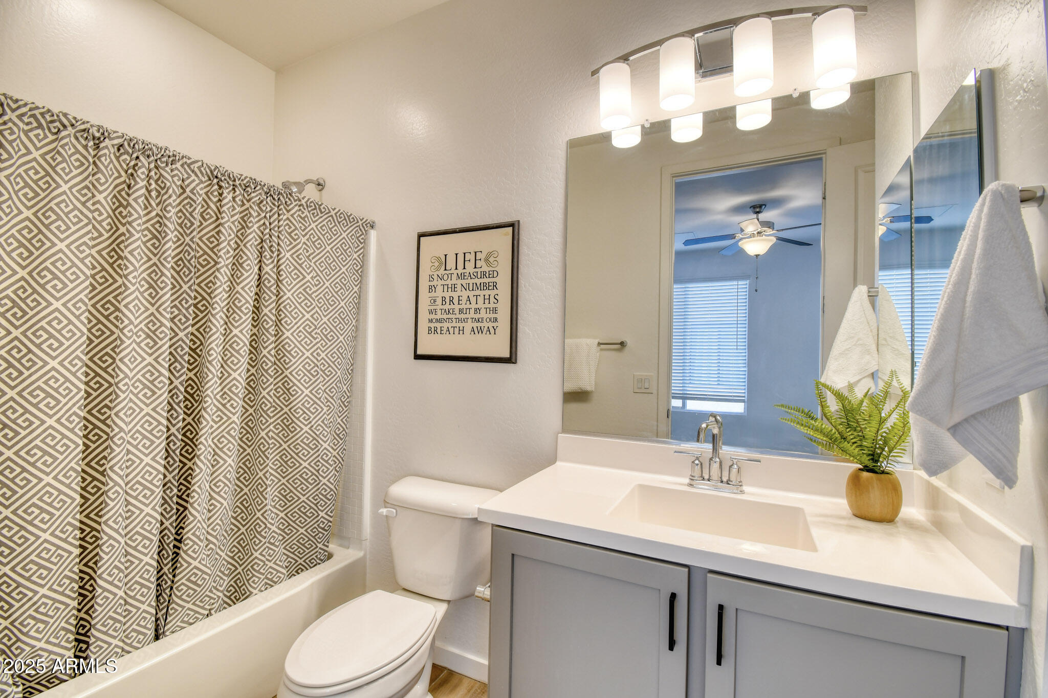 901 South Smith Road, Unit 1065 Tempe, AZ 85281 - Photo 12 of 26 a bathroom with a sink a toilet and shower curtain