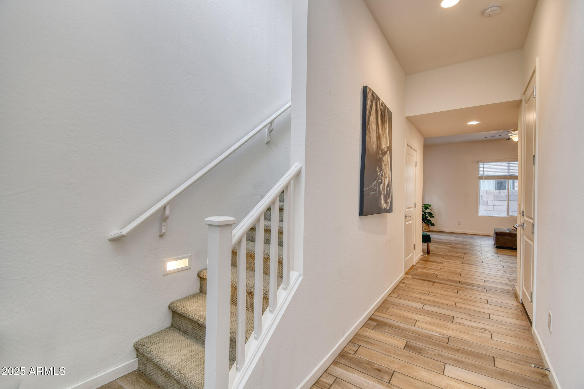 901 South Smith Road, Unit 1065 Tempe, AZ 85281 - Photo 14 of 26 a view of a hallway with the wooden floor and staircase