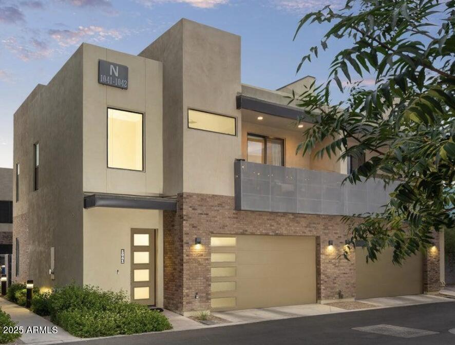 901 South Smith Road, Unit 1065 Tempe, AZ 85281 - Photo 26 of 26 a front view of a house with a yard and garage