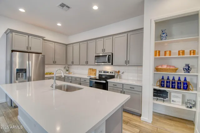 a kitchen with refrigerator a sink and cabinets