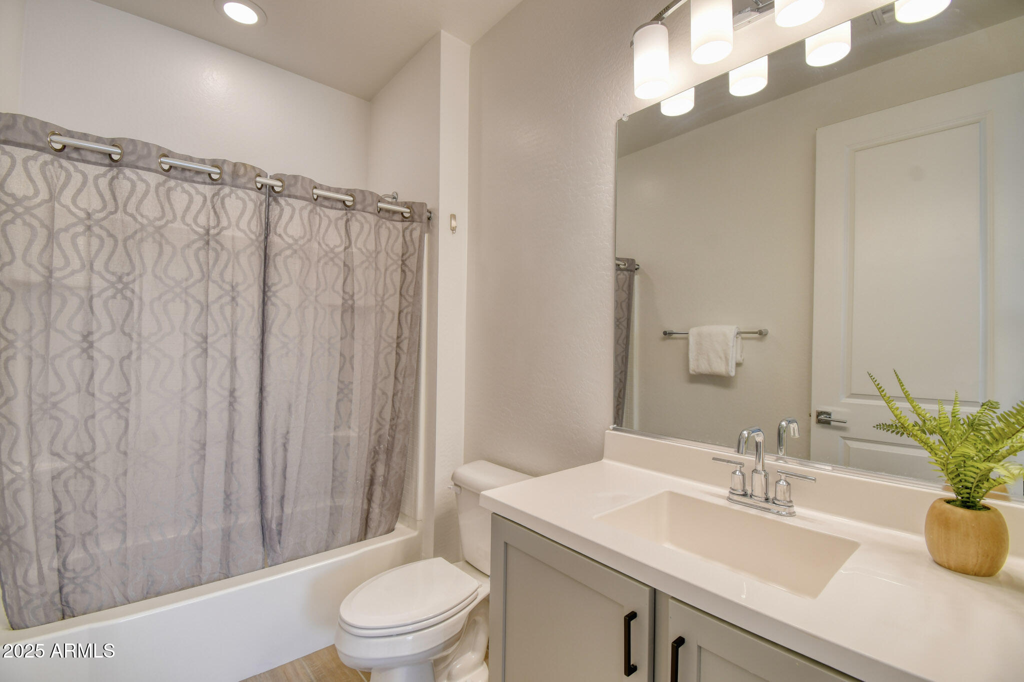 901 South Smith Road, Unit 1065 Tempe, AZ 85281 - Photo 10 of 26 a bathroom with a sink a toilet and shower curtain