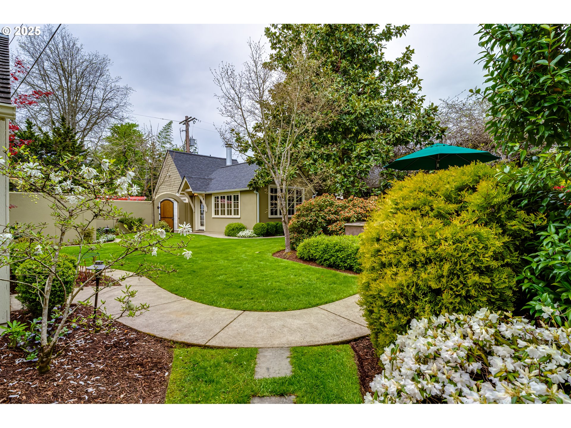 1976 University Street Eugene, OR 97403 - Photo 32 of 36 a view of a house with a yard table and chairs